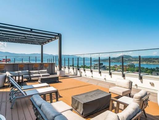 Rooftop terrace with lounge seating, pergola and a view of Okanagan Lake
